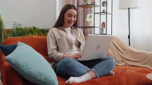 Woman Video Calling on Laptop Computer at Home