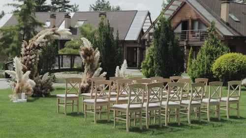 Outdoor Wedding Setup with Chairs and Arch