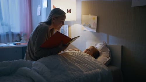 Woman Reads to Child in Bed at Night