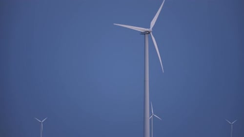 Wind Turbines Spinning Against the Blue Sky