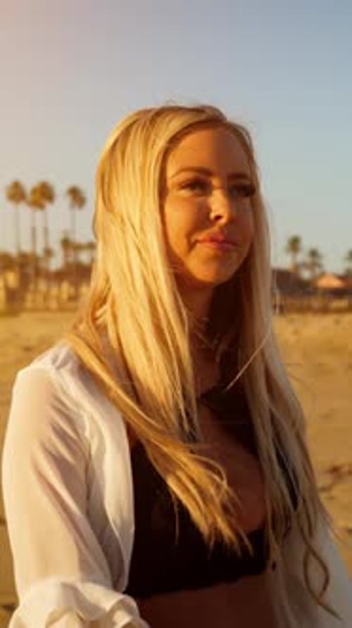 Attractive Blond Woman Walking on the Beach. Vertical Video.