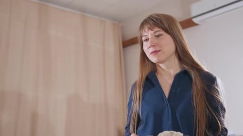 Professional Observes Patient Molding Soil During Therapy Session