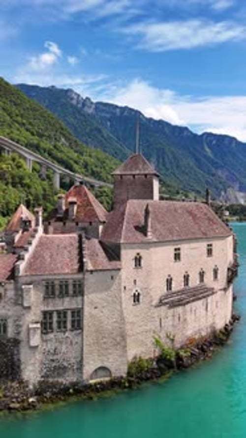 Chillon Castle medieval fortress Lake Geneva shore Lac Léman in Switzerland aerial drone