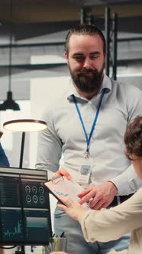 Vertical Video Multiethnic Work Team Consulting Each Other in Completing Monthly Reports