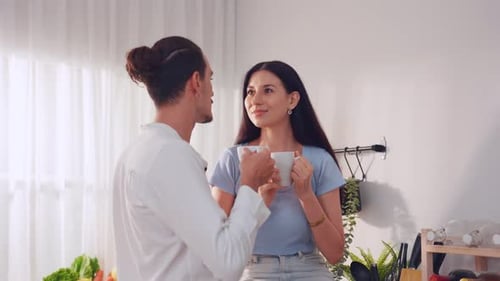 Couple Talking and Drinking Coffee at Home