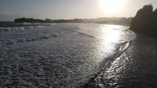 Aerial view of beautiful sunset at Beach in Indonesia with yellow sunny day.