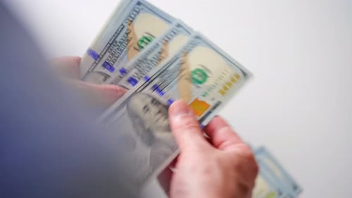 Counting stacks of one hundred dollar bills