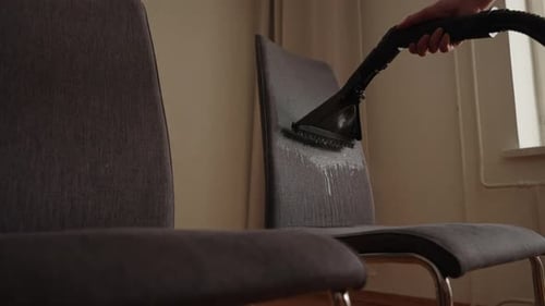 Cleaning Product Being Sprayed on the Back of a Chair