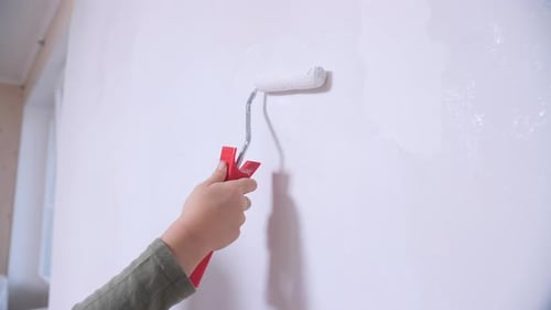 Hand Painting Wall with Roller in Interior