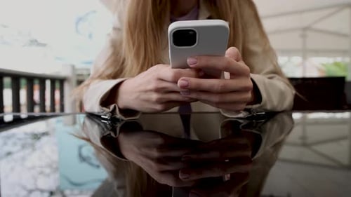 girl woman smoking hookah in terrace restaurant sitting with coffee cup on table,typing message