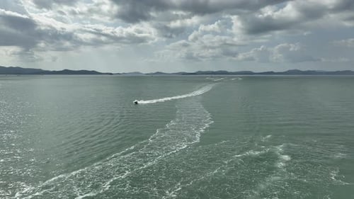 Aerial View of Jet Skis Racing Across a Vibrant Blue Ocean in Thailand