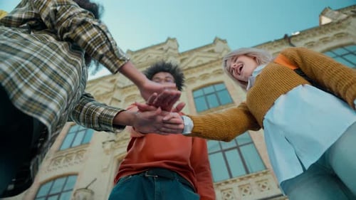 Young Adults Celebrate Together Near School Building