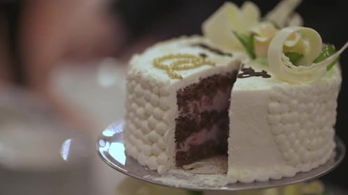 Close Up Of Wedding Cake Cut On Cake Stand