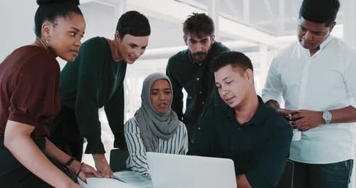 4k video footage of a group of businesspeople using a laptop during a meeting in a modern office