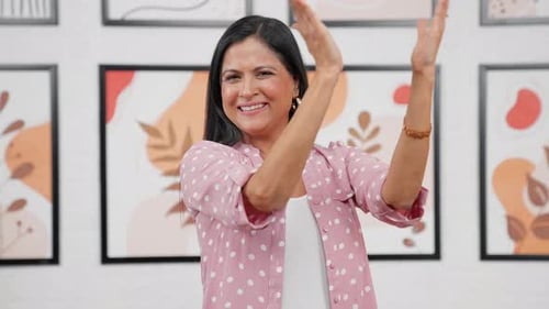 Smiling Woman Applauding in a Modern Home
