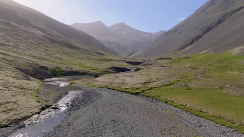 Aerial view of waterfall and river in valley, Iceland.