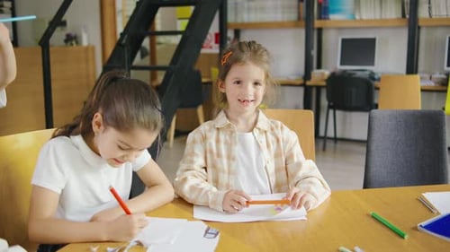 A Portrait of a Young Elementary School Girl Looking Directly at the Camera with a Curious