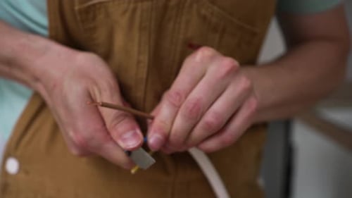 Electrician Removing Casing From Electrical Wire