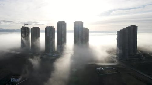 City Buildings Emerging from Morning Fog, Aerial View