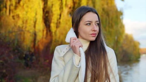 Woman Outdoors in Autumn with Colorful Trees