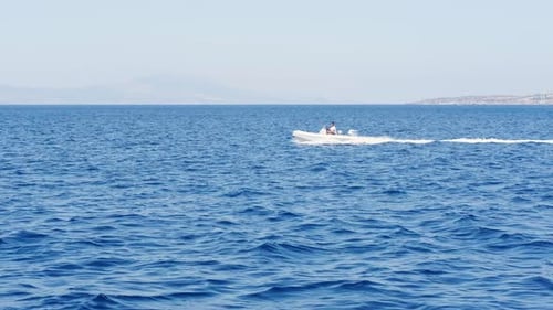 Speedboat Quickly on Blue Water Seascape Blue Sky and Mountains Horizon Line Little Wave at Sea