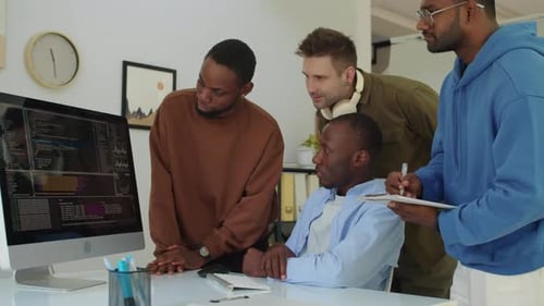 Team of Diverse Programmers Trying to Fix Bags in App Code at Office