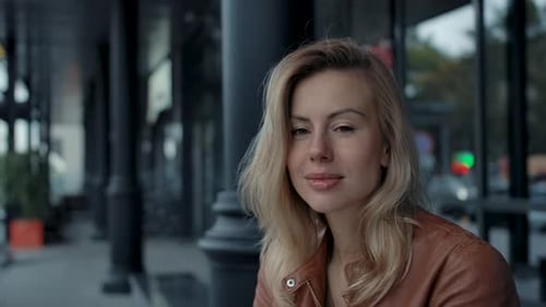 Young 30s Attractive Woman Portrait at City Street Outdoors Looking at Camera