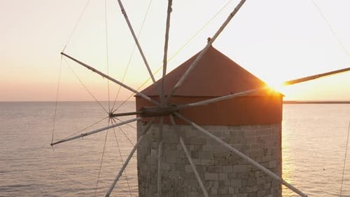 Sunrise at the Old windmills of Mandraki in Rhodes harbour, Greece