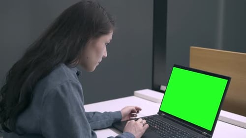 girl studying remotely, holding an online meeting green screen