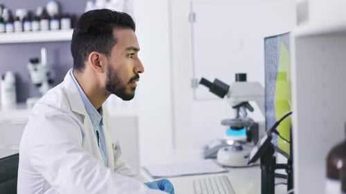 Scientist Working at Computer in Bright Laboratory