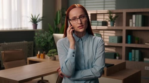 Angry Caucasian Ginger Business Woman Arguing on Mobile Phone Inside Office Irritated Female in