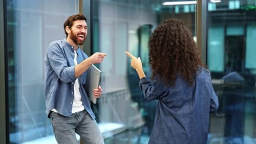 Business Colleagues Celebrate Success with Joyful Dance in Modern Office