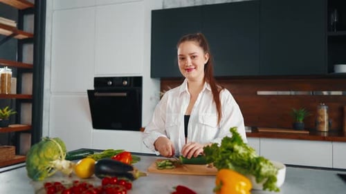 Woman Slicing Vegetables in Modern Kitchen