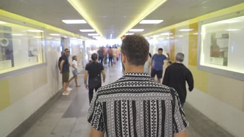 The young man passing through the underpass.