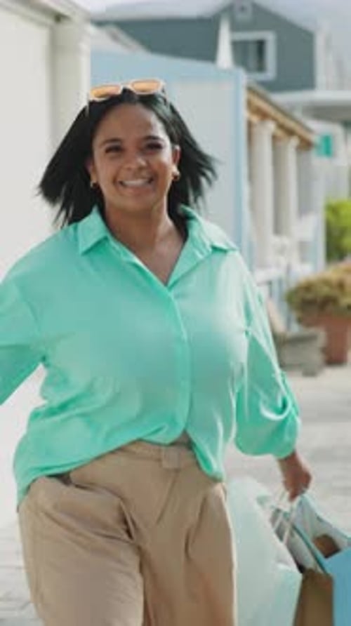 Excited woman, walking or celebration with shopping bags in city for clearance sale or deal