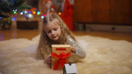 Happy Child Opening Christmas Gift with Toy Car