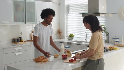 Young Adults Preparing Food Together in Kitchen