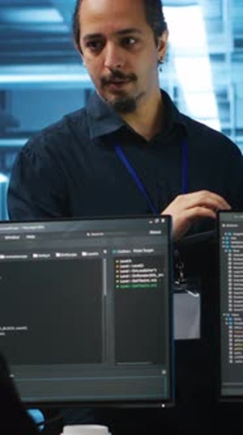 Colleagues Collaborate at a Computer Workstation