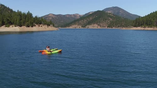 Aerial Drone of Couple Kayaking on Lake