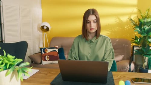 Woman Works At Laptop Then Writes In Notebook