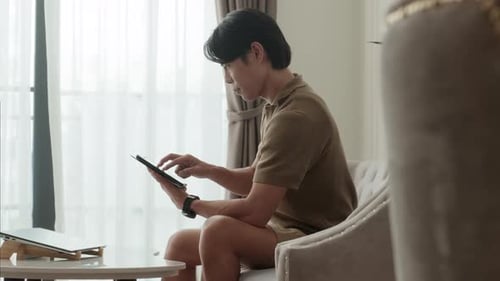 Young Male Freelancer Using Tablet by Workplace in Home Office