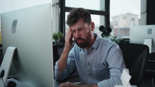 A Dedicated and Focused Professional Engaged in Work on a Computer in a Modern Office Environment
