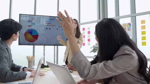 Business Team Engaged in Data Presentation in Office