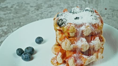 Delicious Waffles with Blueberries and Powdered Sugar