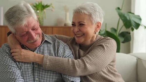 Affectionate Senior Couple Laughing Together at Home