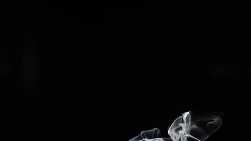 Wispy smoke rising against a black background, artistic effect