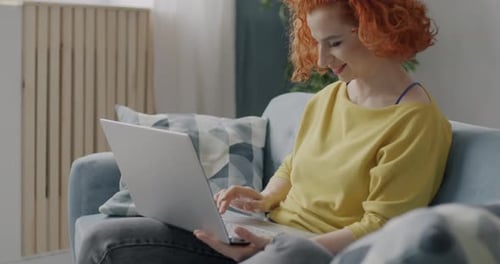Woman Works on Laptop in Living Room