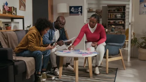 Family Stringing American Flags for Independence Day