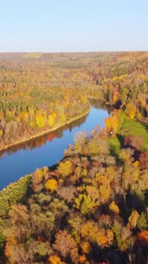 Autumn aerial view of Sigulda Latvia with vibrant fall foliage surrounding a winding river
