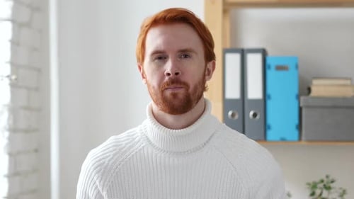 Man with Red Hair Points Directly at the Camera